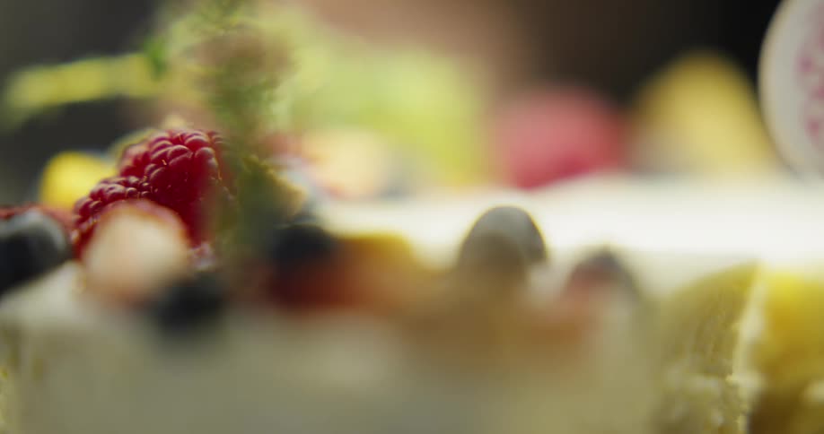 Slices of cheesecake covered in various fruits