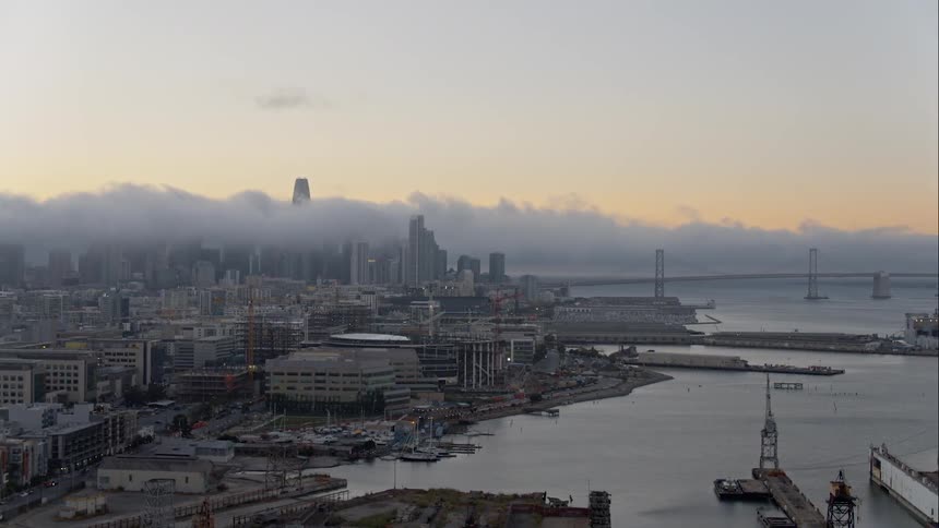 A city sits on the shore by a large bay