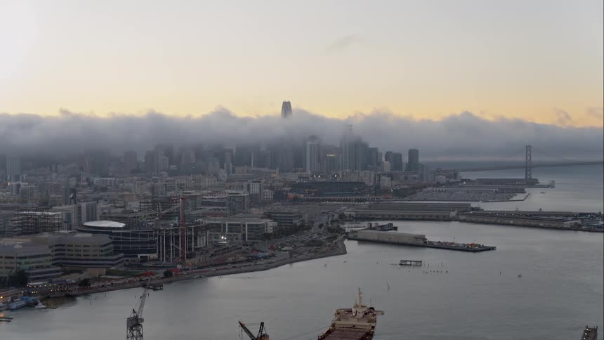 The heavy clouds are moving over the city ahead