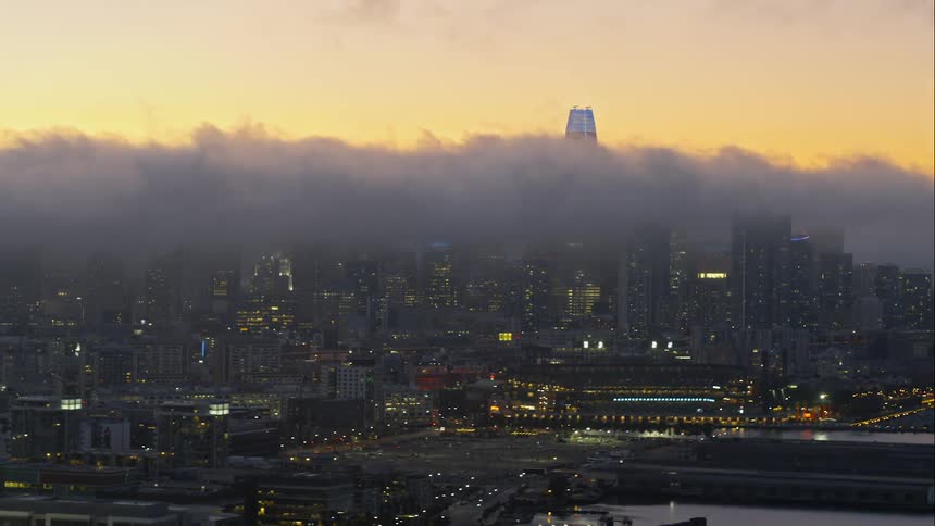 A cloud bank floats over a large urban area