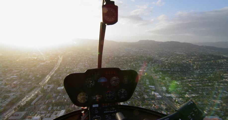 A helicopter flies over a city