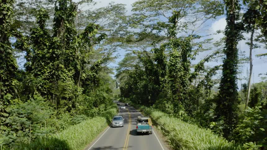 Cars drive along road separating valleys