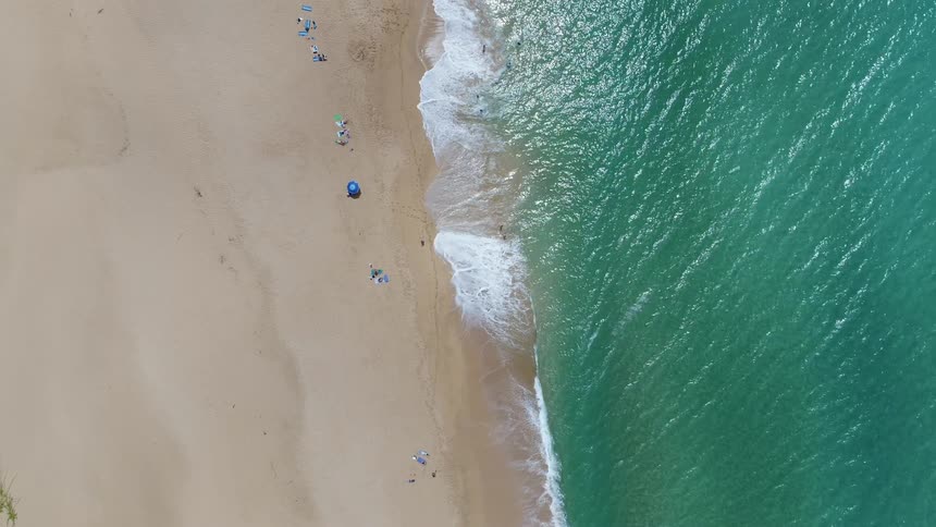 Waves crash into a sandy beach