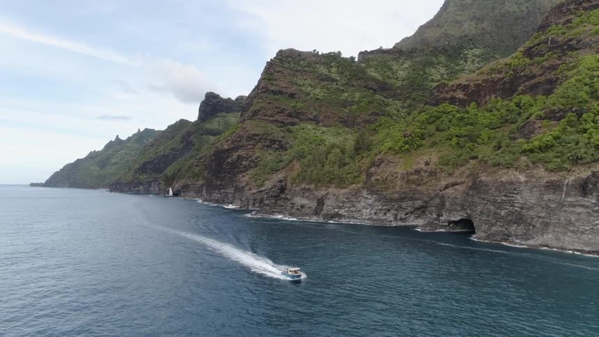 A boat is sailing past the shore