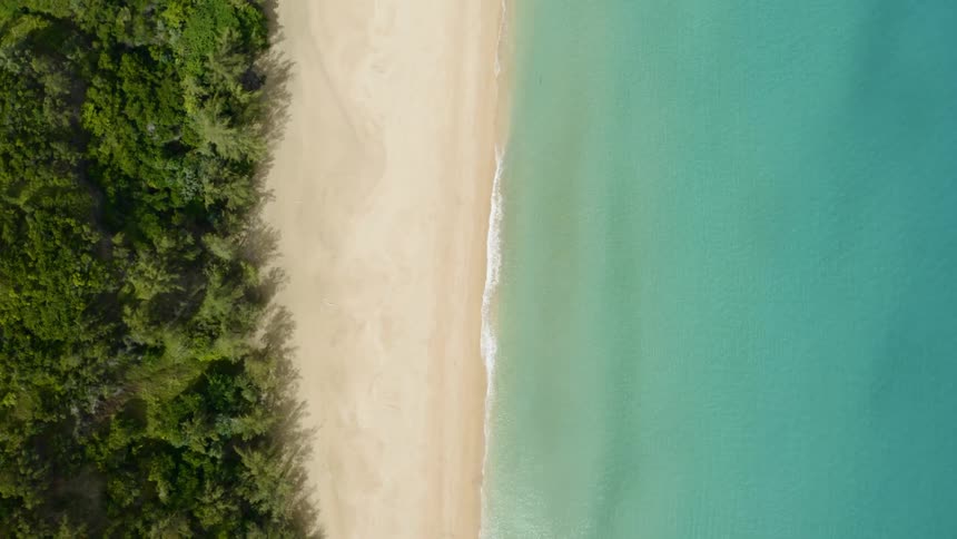 The beach has calm blue waters on the side