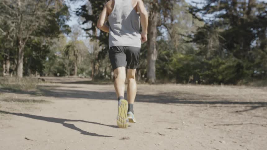 A man is running along a dirt path