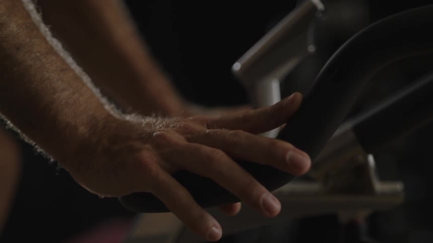 A person is using a exercise machine to work out