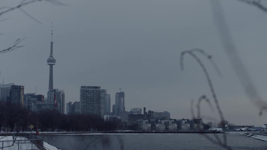 A gray sky hangs over a large city