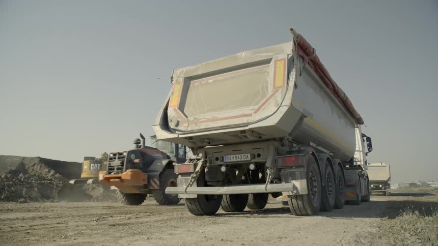 Large construction trucks at a construction site