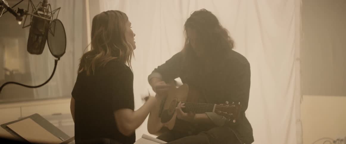 Females playing guitar and sing
