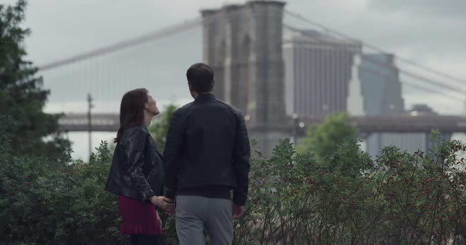 Couple walk in the public park near brooklyn bridge
