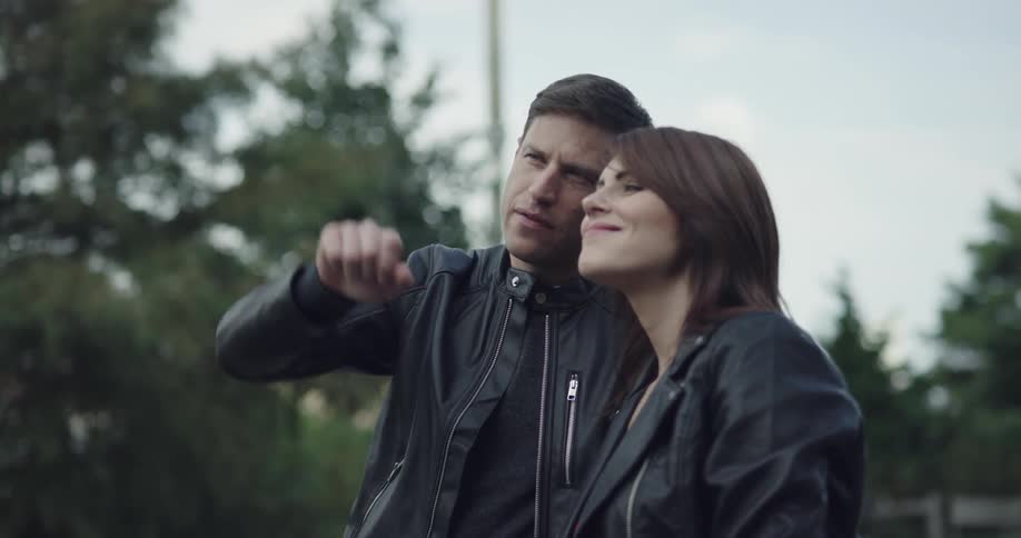 Couple pointing and staring at something on the public park