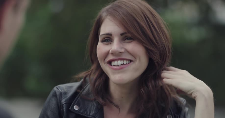 A pretty woman flirts with a man sitting across from her