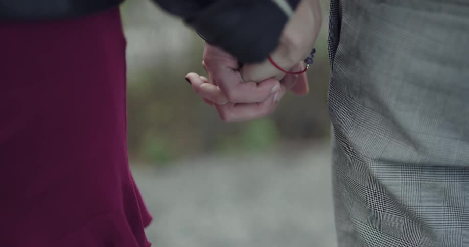 A couple holding hands romantically