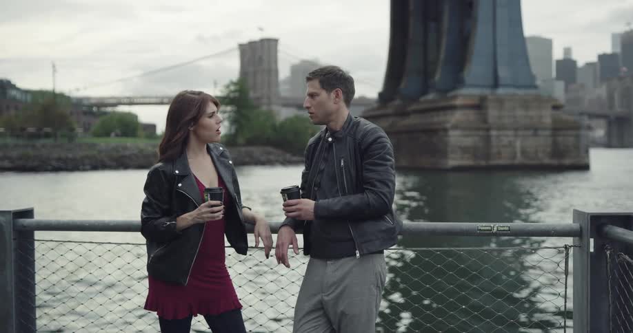 Two people chatting by the water