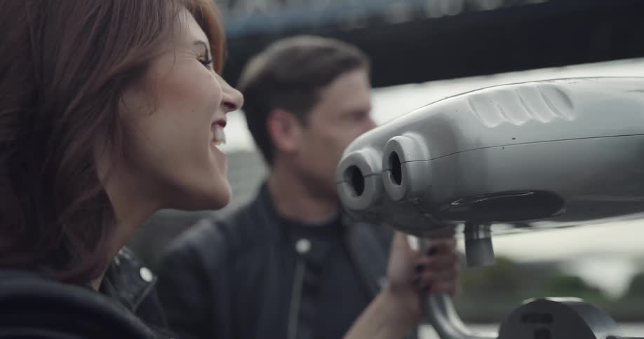 Woman playing with binocular with her boyfriend