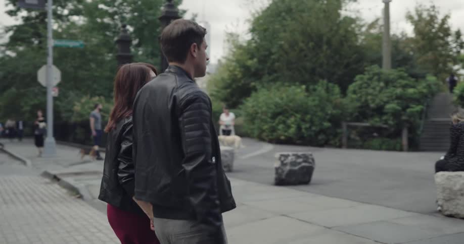 Couple walks in the downtown on the way to the public park