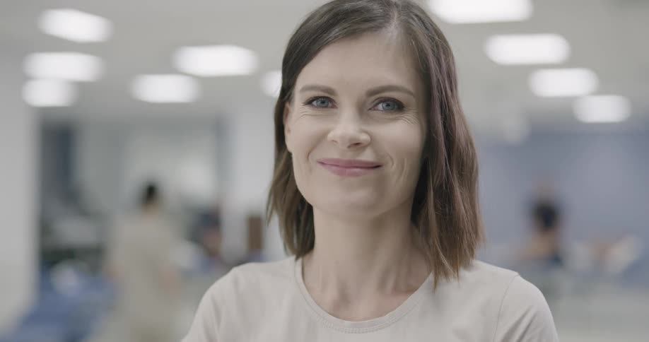 Woman smiles as she poses for the camera