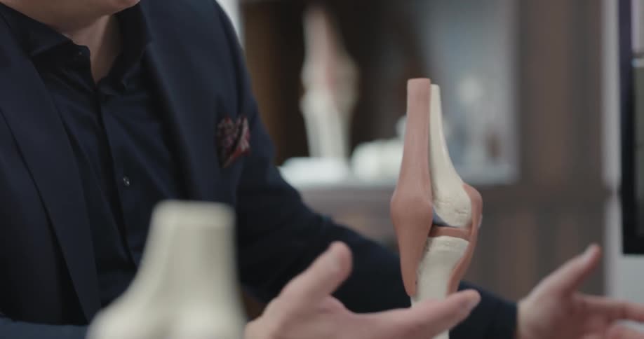 A man talks about bones in his office
