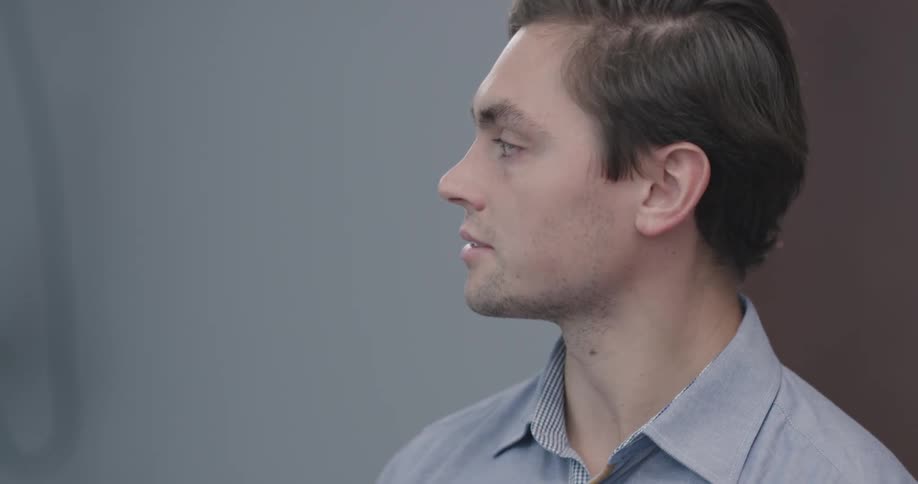 A young man nods and talks to someone