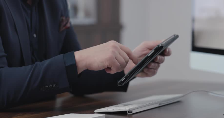 A man is using his tablet in the office
