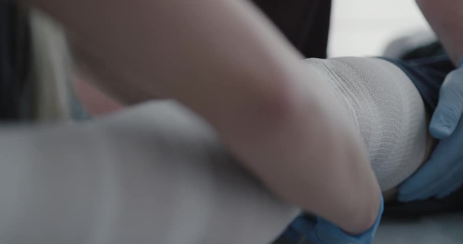 Woman wraps a bandage around a patients leg