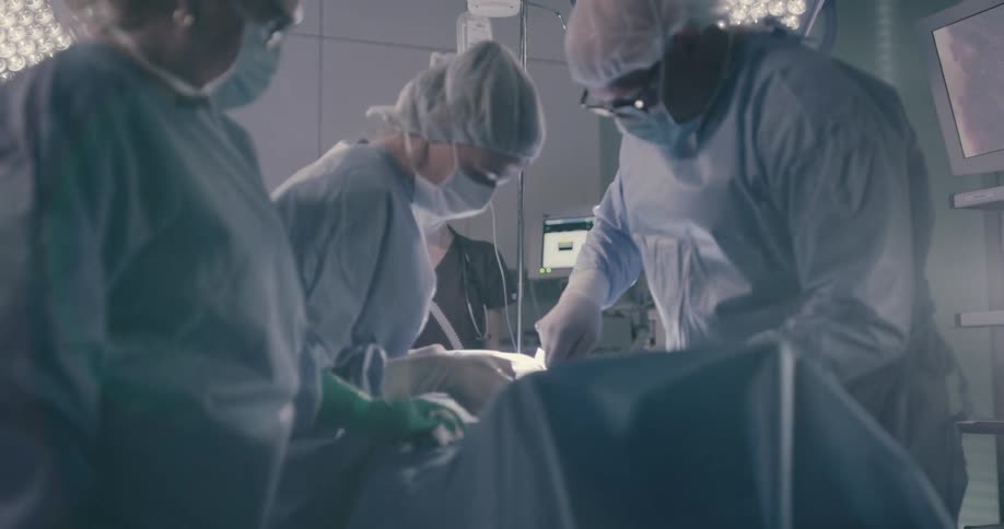 Surgical team operate in operating theater