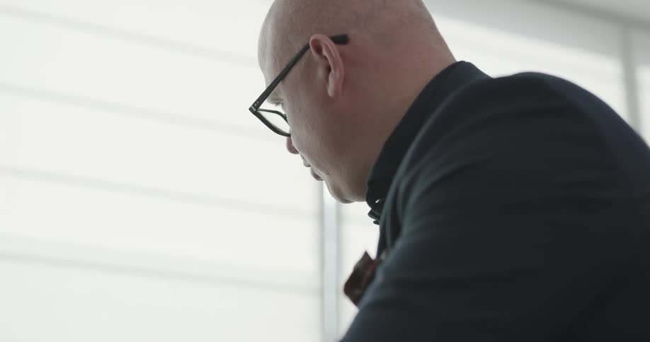 A man talks to another person as they examine them