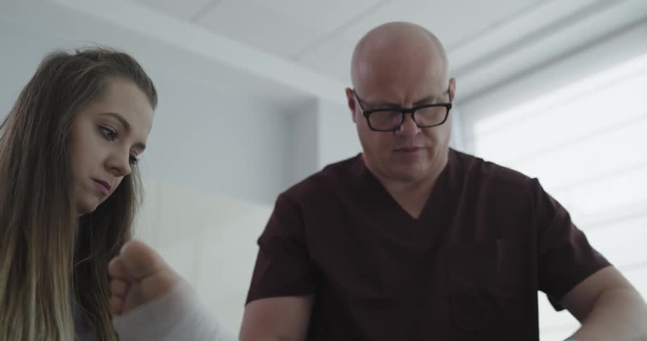A doctor is helping a patient at a hospital