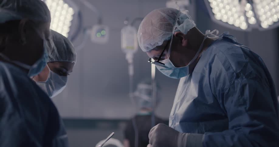 Doctor doing surgery to the patient with the help of nurses