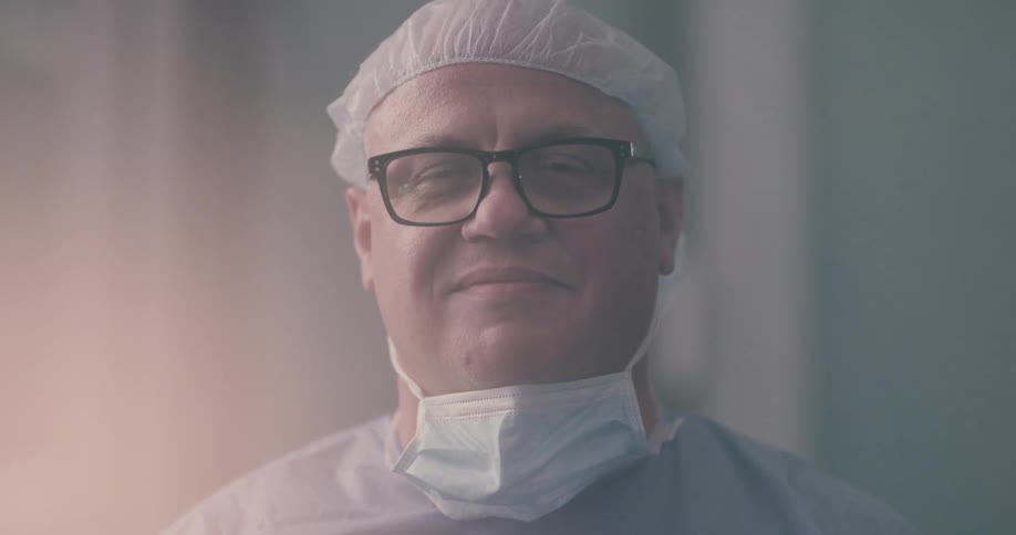A doctor with hat releasing his mask after the surgeon