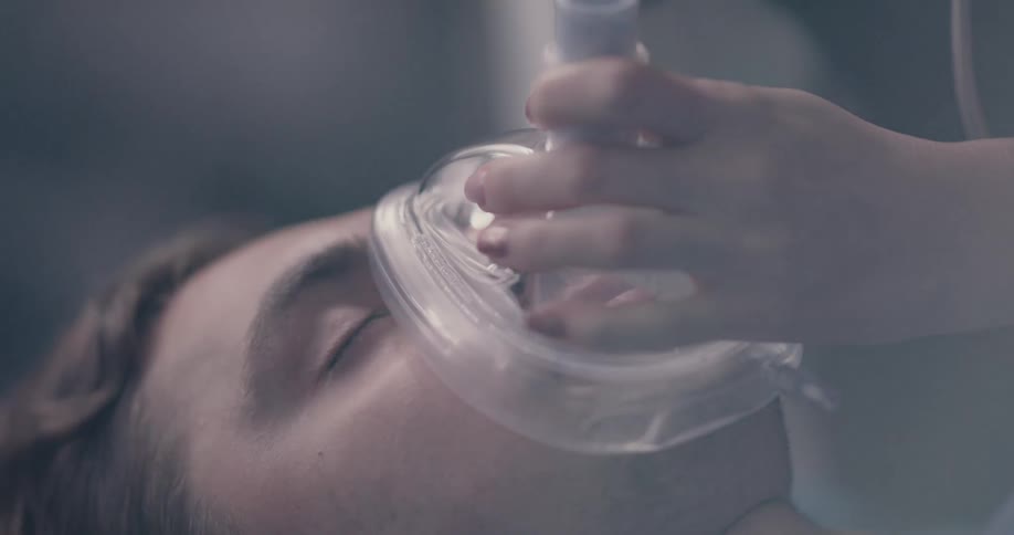 An unconscious man is given a breathing devices