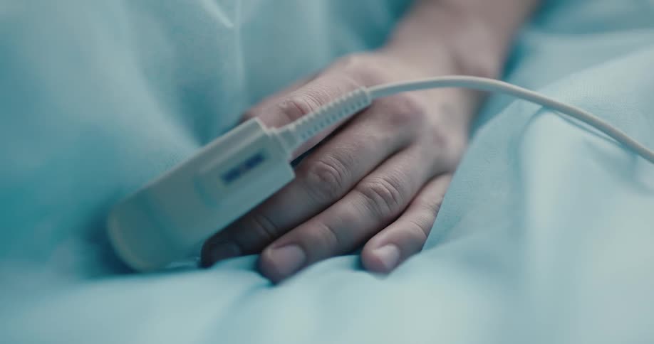 A patient with a medical device on her finger keeps track of her status