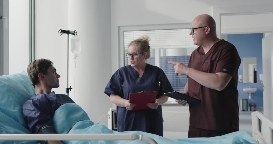 A man shakes hands with a doctor in the hospital