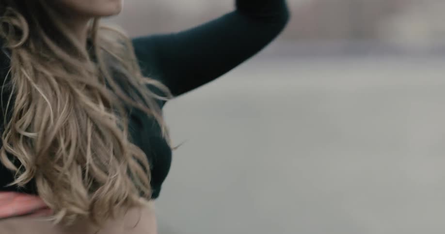 Woman takes off shirt and warms up before running in new york city on a cloudy day