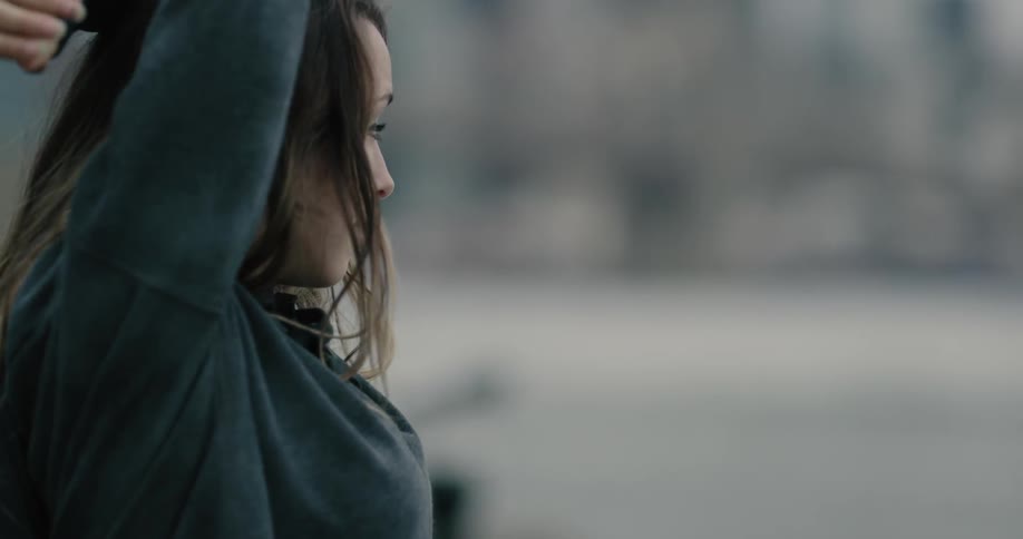 Female with long hair stretching outdoors