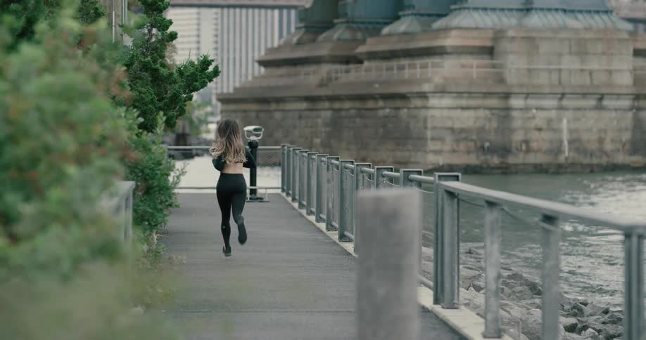 Young woman running on the public park