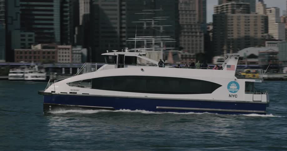 A boat with people on it is driving in the ocean