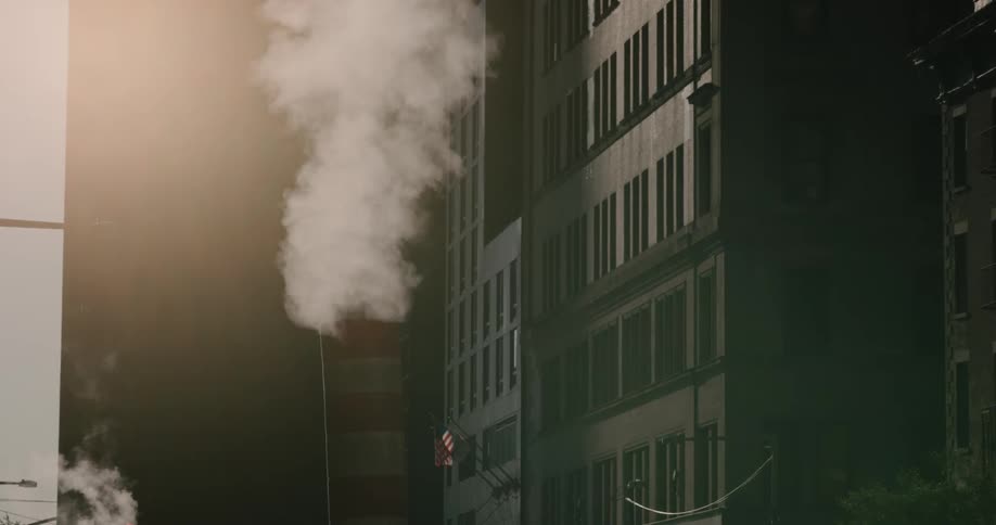Smoke leaves smoke task next to tall building