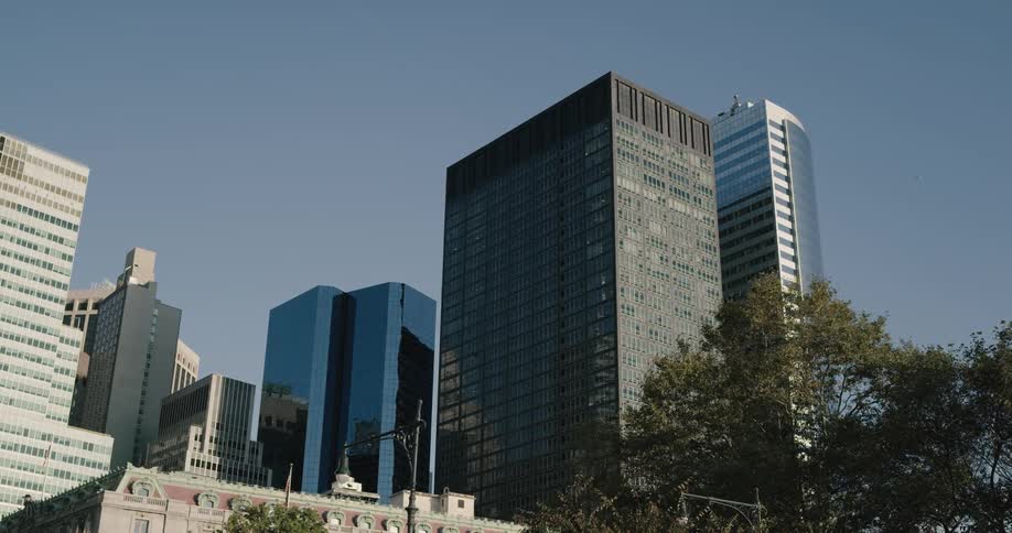 Buildings in a city sit under a blue sky