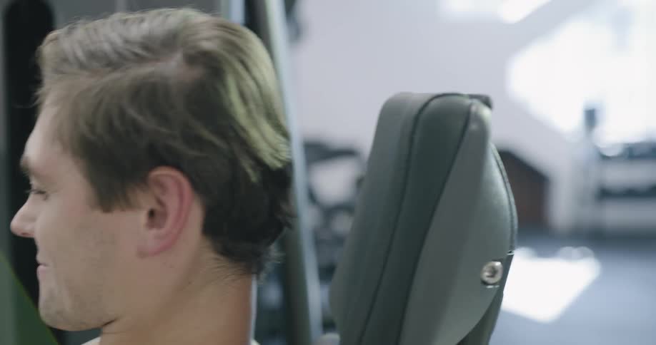 A man using a leg machine at a gym