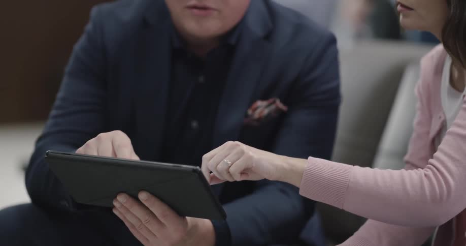 People look at something on a tablet