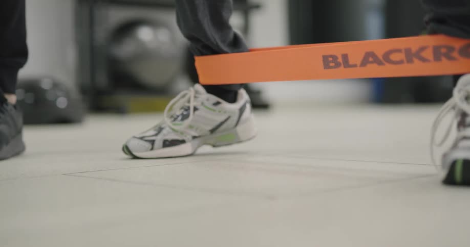 Man doing a walk exercise with a strap on his foot