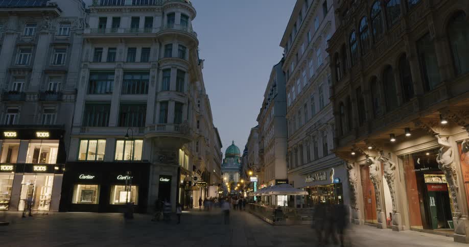 People walk by in a bustling city at night