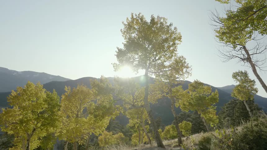 Sun sets behind a range of mountains