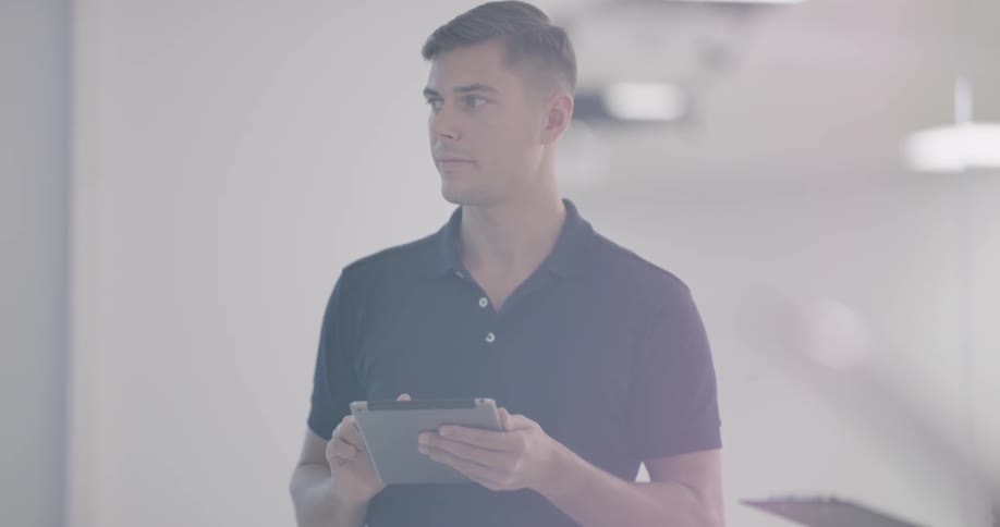 People are in a room looking at a tablet