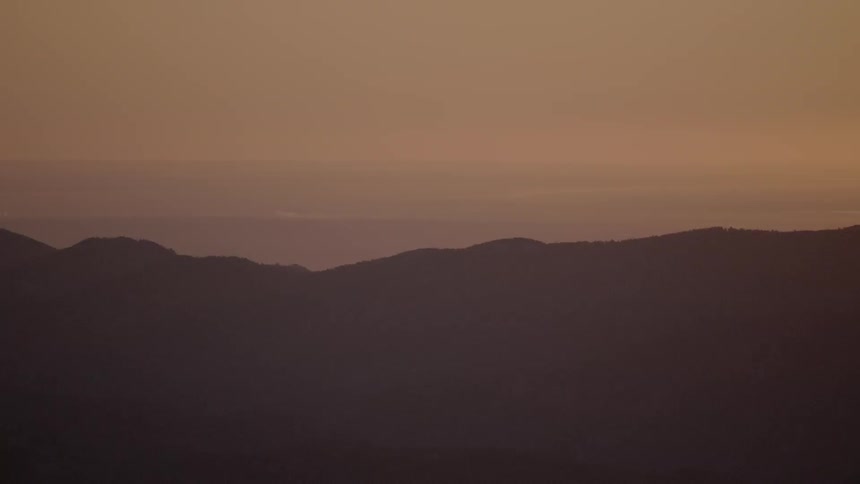 The silhouette of a hill ridge landscape at sunset
