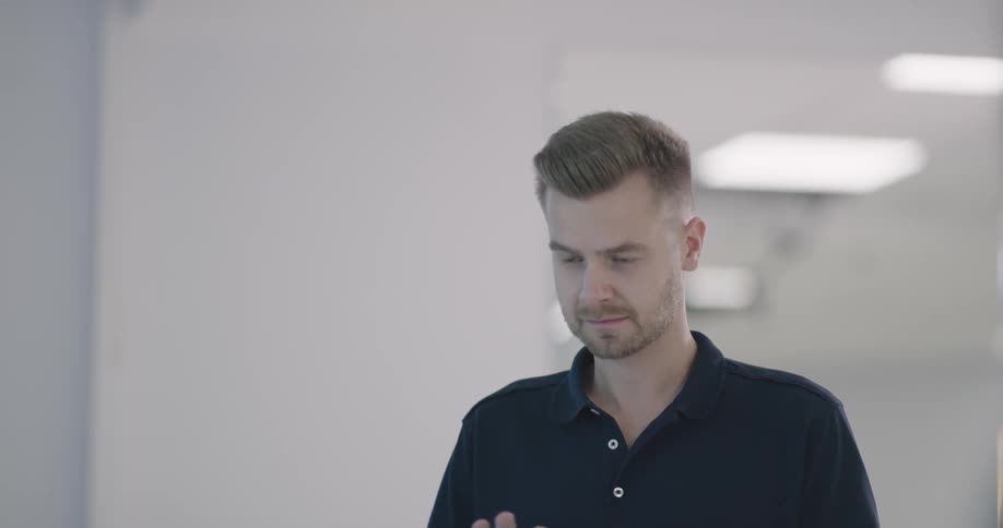 A man look at the room surrounding with a tablet on his hand