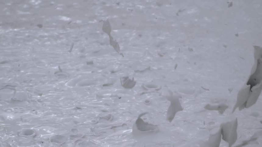 Pale bubbling liquid erupts