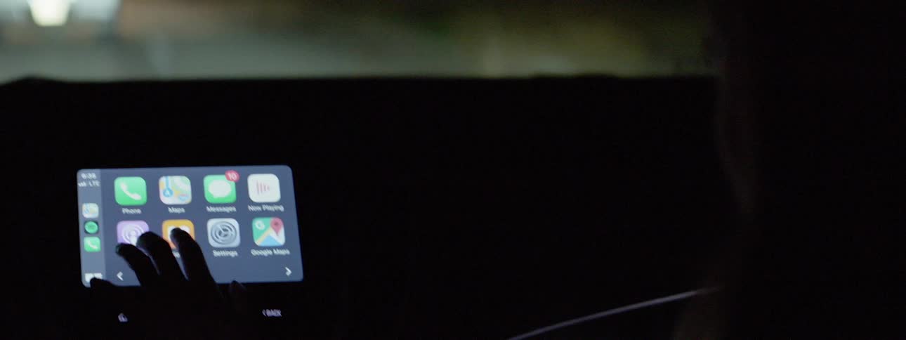 Human using touchscreen device on the car dashboard